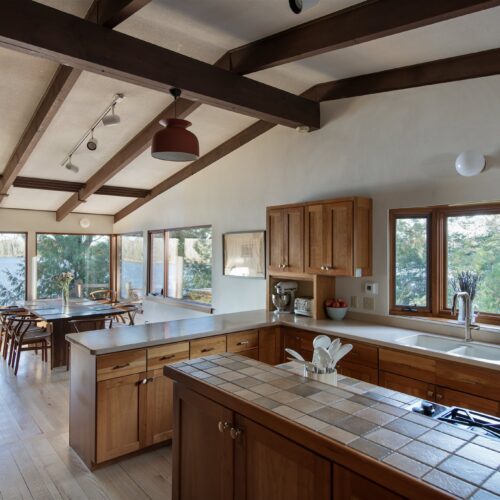 Cook with panoramic lake views in a fully stocked, design-forward kitchen.