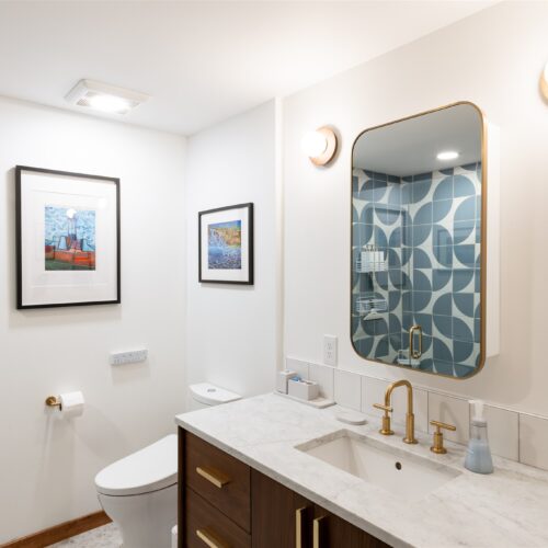 A bright, polished bathroom with warm tones and modern finishes.