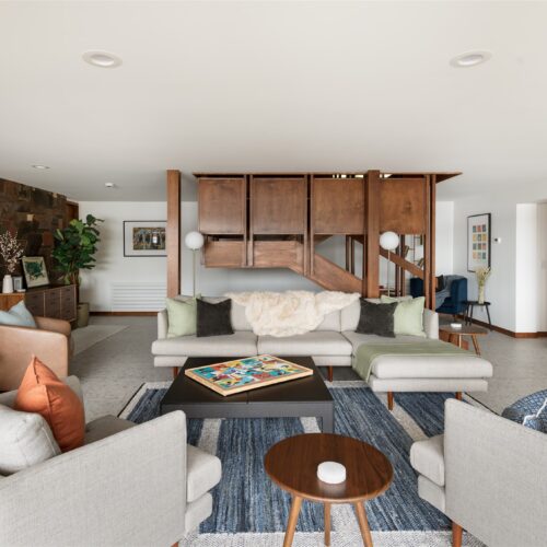 A comfy game room designed for fun and movie nights.