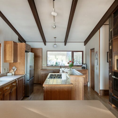 A warm, modern kitchen blending mid-century design with everyday convenience.