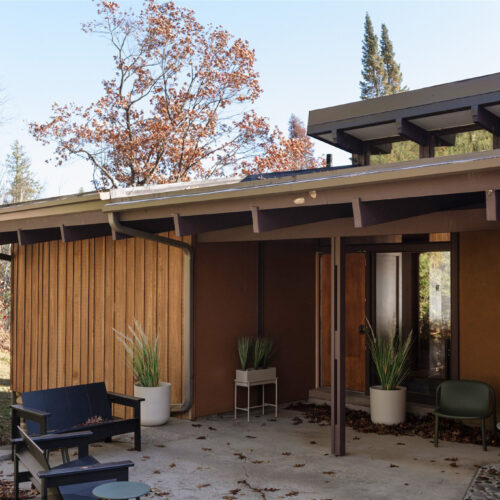 A welcoming entry patio with modern seating and natural textures.