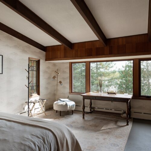 A serene king suite designed for rest, comfort, and lake-view mornings.