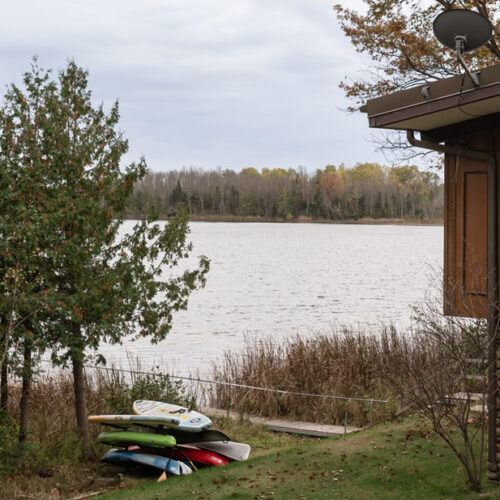 Kayaks, paddleboards and canoes are ready and waiting for peaceful paddles on this quiet lake.