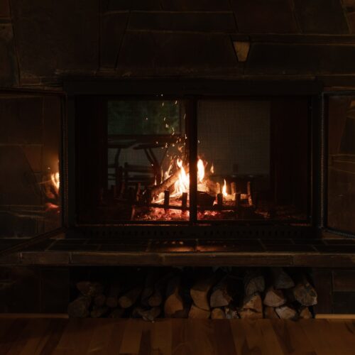 Flickering firelight and natural stone set the tone for cozy winter nights.