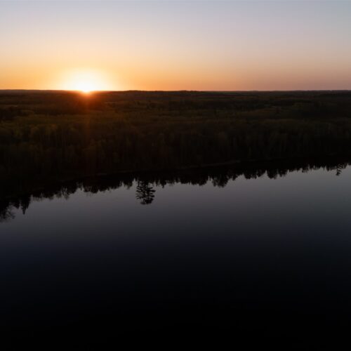 Sunrise over a perfectly still lake. Pure Northwoods magic.